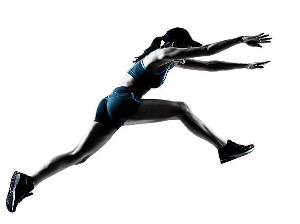 A woman who is jumping to start running  one caucasian woman runner jogger jumping in silhouette studio on white background long jump stock pictures, royalty-free photos & images