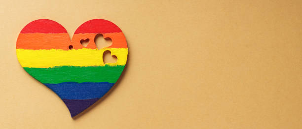 istock Heart in rainbow colors on beige background. LGBT equal rights movement and gender equality concept. Copy space 1497270464