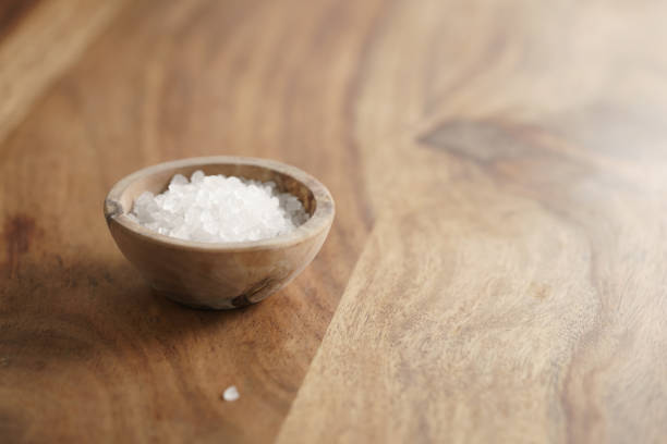 istock coarse sea salt in wooden bowl on table 1497271720