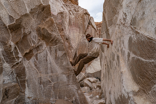 A man standing in between huge Salt Rocks in Garmsar of Iran