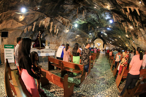 bom jesus da lapa, bahia, brazil - june 5, 2023: Devotees attend mass in church inside a grotto in Bom Jesus da Lapa sanctuary.