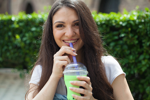 Young woman drinking matcha bubble tea