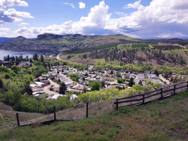 Beautifully located Motor home park in Vernon BC. Kalamalka Lake in background. University tree farm on hillside.  Month of May.