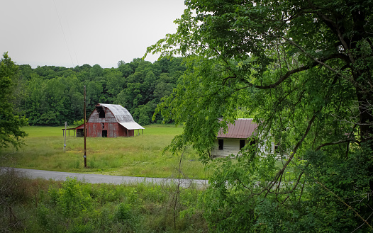 A view of an abandoned farm with an old barn in rural Tennessee