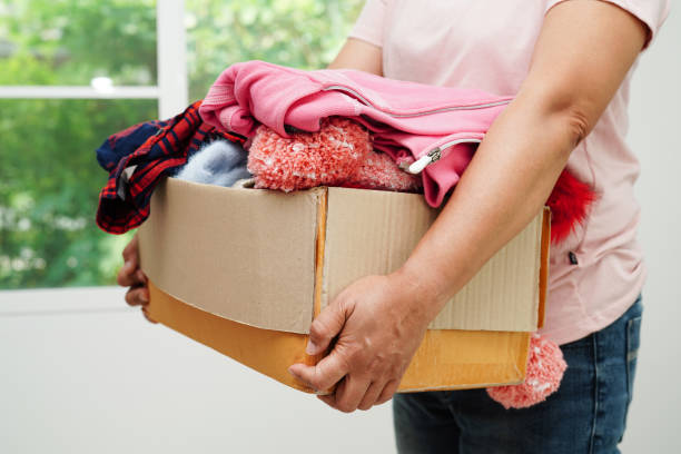 istock Clothes donations in cardboard box for volunteer. 1497288724