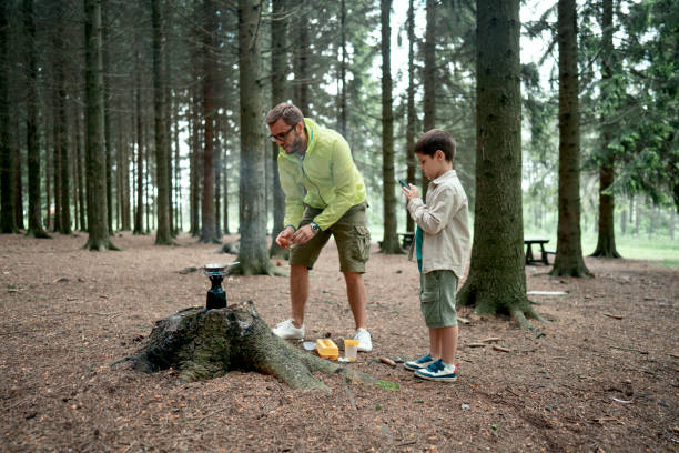 istock Father and son preparing a meal in the nature 1497289516