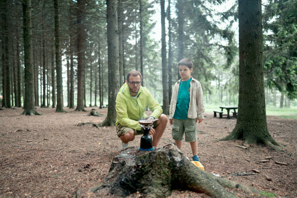 istock Father and son preparing a meal in the nature 1497289519