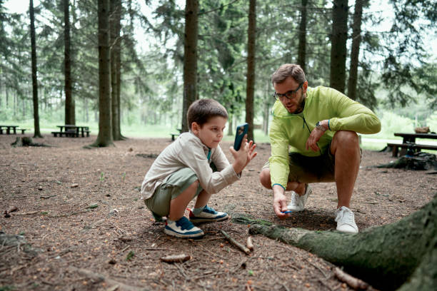 istock Little boy and his father exploring the nature 1497289560