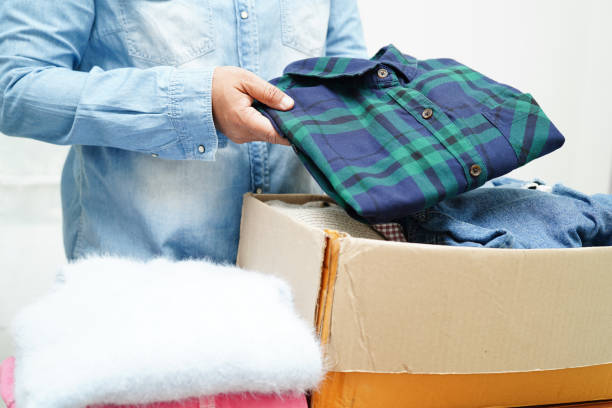 istock Clothes donations in cardboard box for volunteer. 1497289621