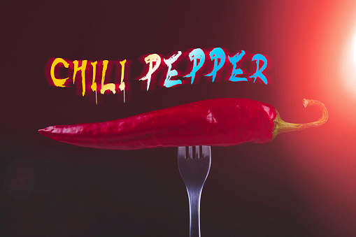 Hot chili peppers on fork. Extra spicy. Mexican food with pepper. Seasonings and spices. Hellish seasoning..
