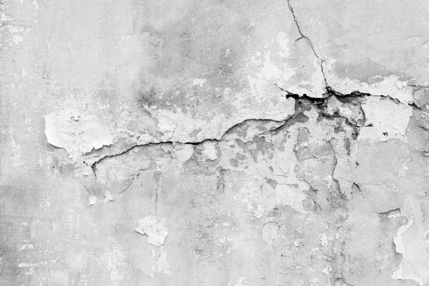 istock Old wall with deep cracks. Grunge gray color texture. Destruction on the surface of the wall. 1497298030
