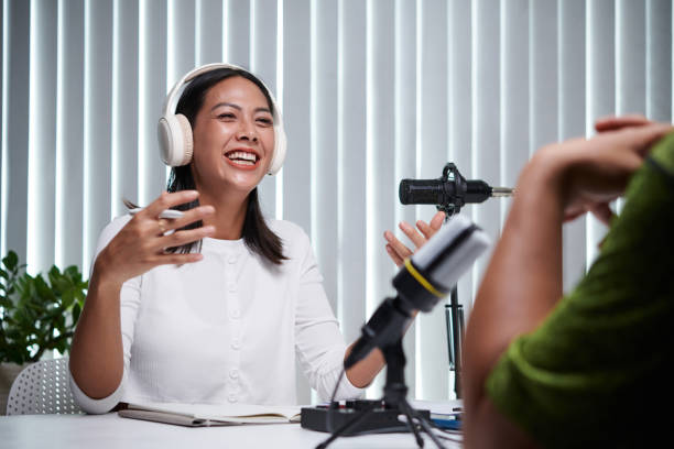 istock Laughing Podcaster Talking to Guest 1497298455