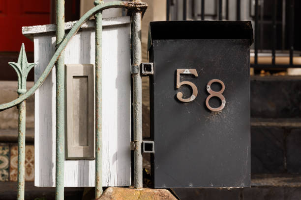 istock Two wooden and metal mailboxes on a fence 1497302309