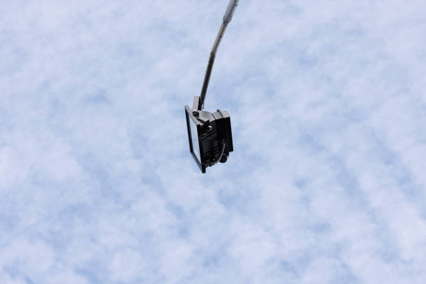 Looking up at an LED streetlight and cloudy sky.
