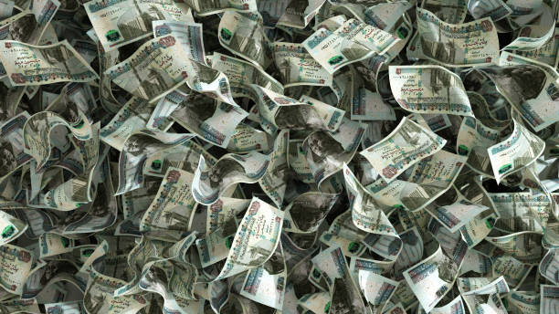 istock 3D rendering of lots of 100 Egyptian pound notes spread on surface. money background 1497306172