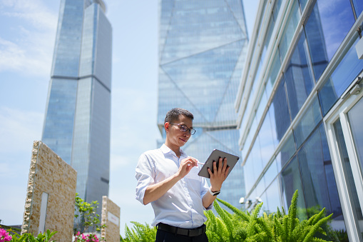 Company employees using tablet computers outside the building
