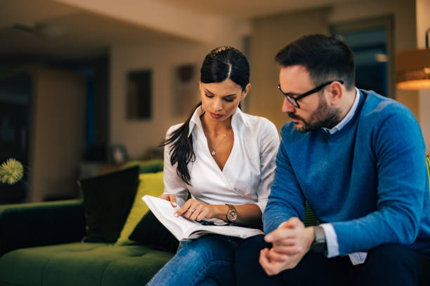 istock Female and male employees reading notes from notebook, sitting at the office. 1497307043