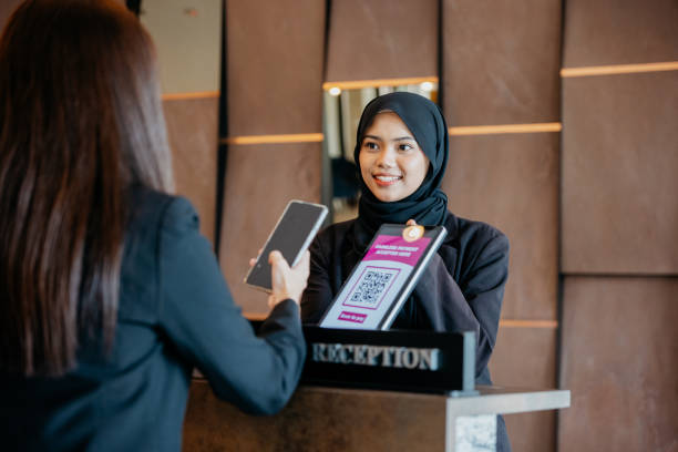 istock Smartphone contactless payment at hotel reception 1497307400