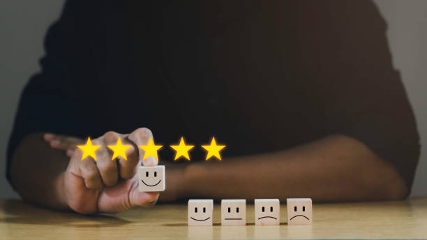 istock Customer services best excellent business rating experience. Satisfaction survey concept. Businessman chooses a happiest face on wood block. 5 Star Satisfaction. 1497308395
