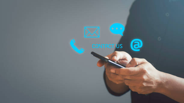 istock Customer support hotline Contact us people connection. Businessman using Smart Phone with the email, call phone, address and chat message icons. 1497308435