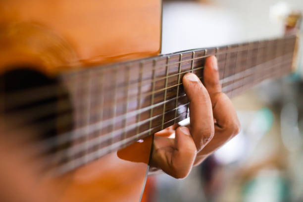 Playing Guitar playing chord stock pictures, royalty-free photos & images
