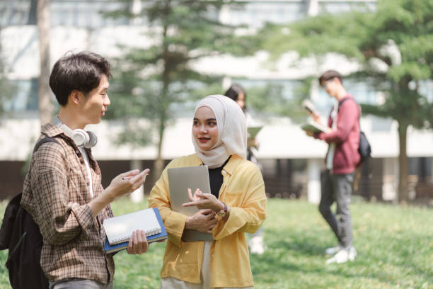 istock A multiethnic group of university students is studying together for an exam while standing near the campus. 1497319639