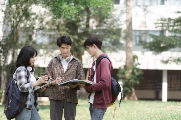 istock A multiethnic group of university students is studying together for an exam while standing near the campus. 1497319645