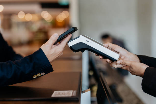 istock Smartphone contactless payment at hotel reception 1497321080