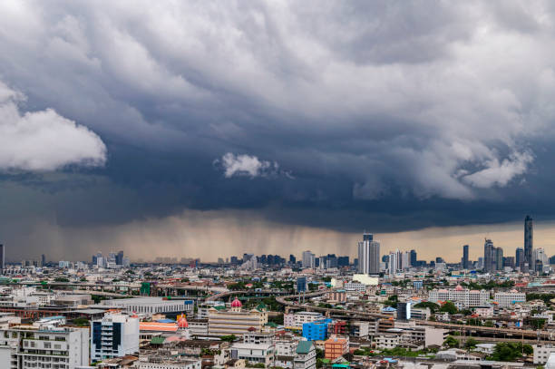 A heavy storm with rain and dramatic atmosphere clouds can be a sight to behold over a city center. stock photo