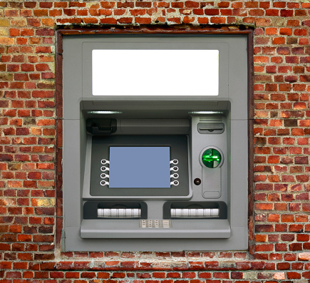 Atm Machine on old red brick wall.