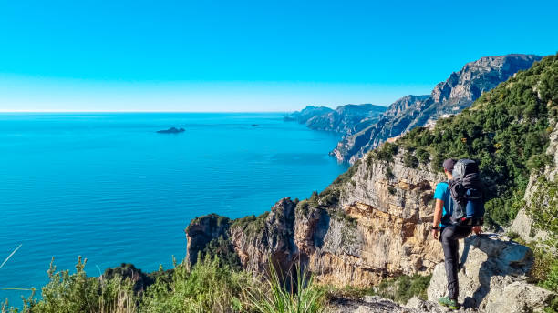 istock Praiano - Man with backpack enjoying scenic view from hiking trail between Positano and Praiano at the Amalfi Coast, Campania, Italy, Europe 1497326995