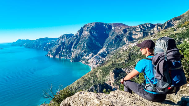 istock Praiano - Man with backpack enjoying scenic view from hiking trail between Positano and Praiano at the Amalfi Coast, Campania, Italy, Europe 1497326996