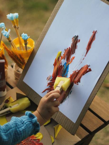 istock A child painting with recycled materials 1497327018