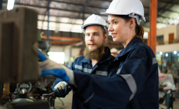 istock Both of mechanical engineers are checking the working condition of an old machine that has been used for some time. In a factory where natural light shines onto the workplace 1497331783