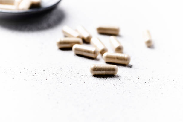 istock Ashwagandha (Withania somnifera) capsules. Bright paper background. Close up. Copy space. 1497331802