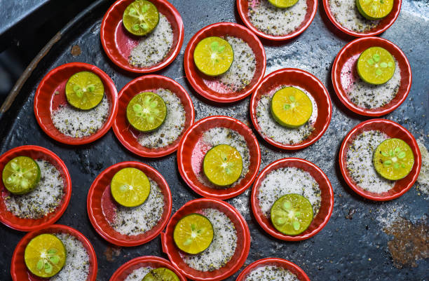 many prepared plates with vietnamese spices with salt, pepper, lime - lime market vietnam fruit imagens e fotografias de stock