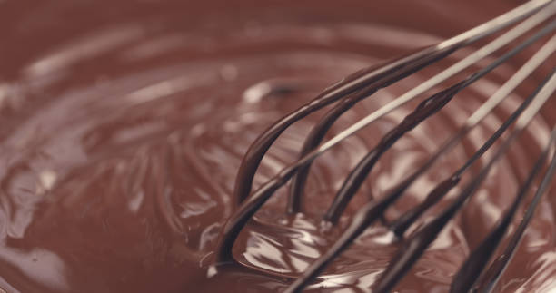 istock mixing melted premium dark chocolate with a whisk toned 1497334754