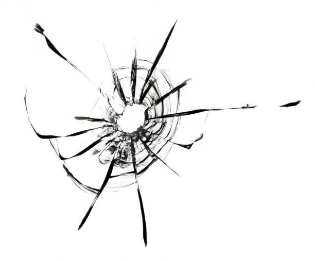 istock A hole in the glass on a white background. Broken window with crack textures, effect for design. 1497335694