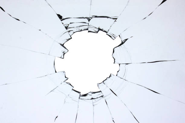 istock Hole in the glass, broken window with cracks texture. Effect of broken transparent glass. 1497335703