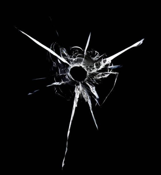 istock Broken glass, shot crack texture through bullet window. Abstraction cracks on a black background. 1497335741