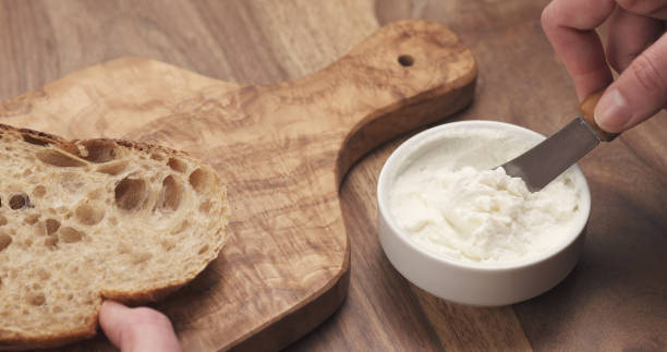 istock taking ricotta cheese to spread on bread 1497335915