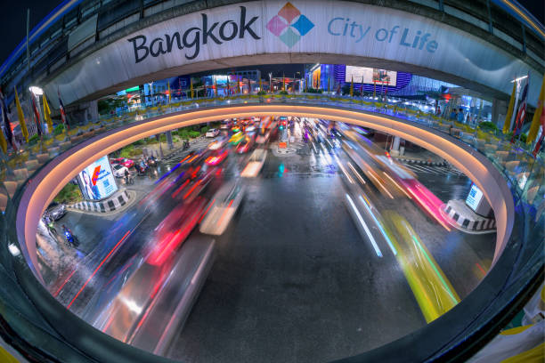 cars light trail traffic near mbk mall in bangkok city at night , tourist destination for famous food, drink, shopping in thailand. - mbk imagens e fotografias de stock