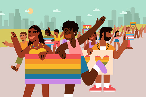 A multiracial group of young LGBTQIA adults hold pride flags and cheers in pride parade.