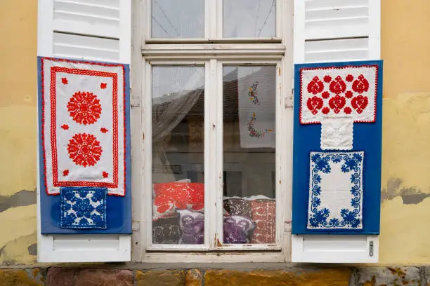 Szentendre, Hungary - November 30th, 2022: Colorful traditional Hungarian embroidered items, in a window in the Hungarian village Szentendre.