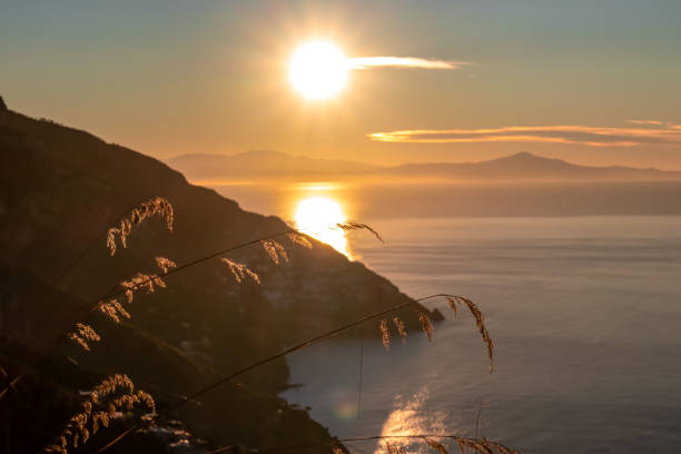istock Praiano - Selective focus on grass with panoramic sunrise view from the Path of the Gods between Positano and Praiano on the Amalfi Coast, Campania, Italy 1497341780