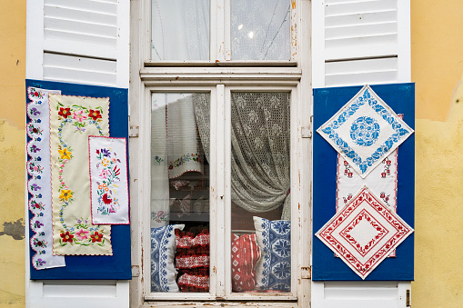 Szentendre, Hungary - November 30th, 2022: Colorful traditional Hungarian embroidery and lace items, in a window in the Hungarian village Szentendre.