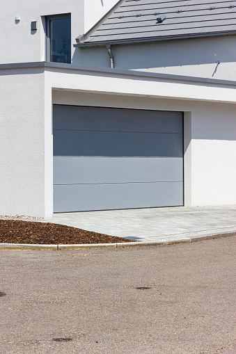 garage carport on a modern house facade in south germany city at summer sunshine and blue sky