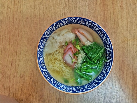 Pork wonton soup noodles with Cantonese vegetables and red pork.
