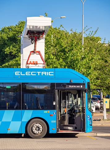 Gothenburg, Sweden - May 30, 2023: One of the Volvo electric buses is being charged at an ABB electric charging station in Gothenburg