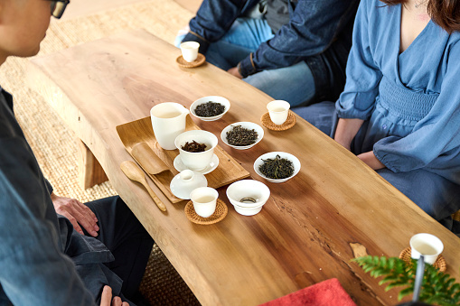 Tea brand owner run his small business and introduce and serving Chinese tea in a tea ceremony to his customer.